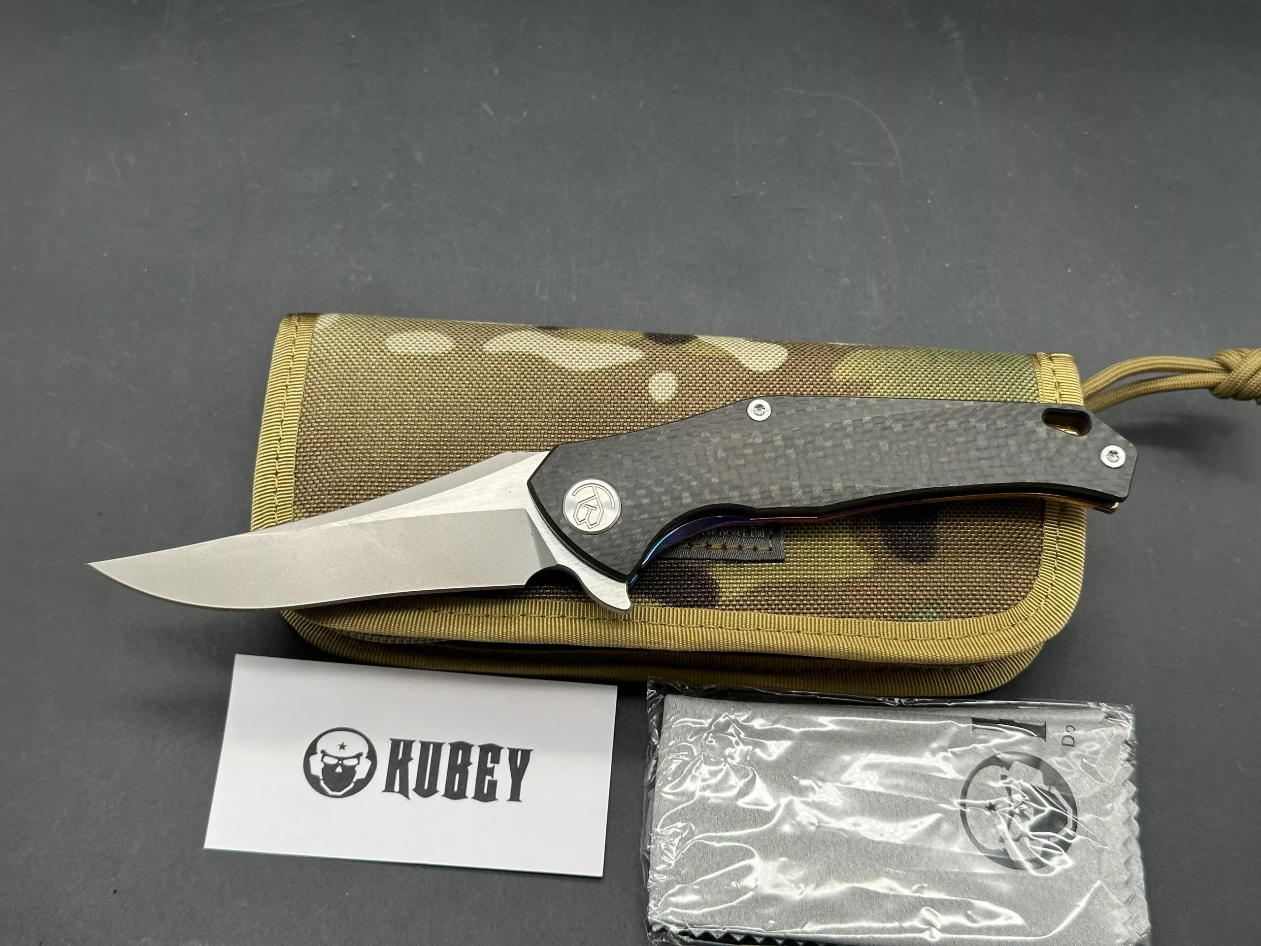 Kubey Caiman colored titanium frame with Carbon Fiber scale